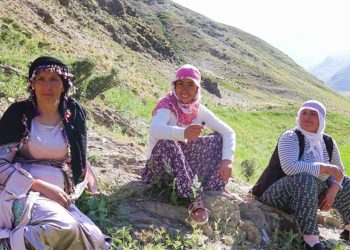 Three women Dengbejs sing traditional Kurdish songs on top of a mountain plateau