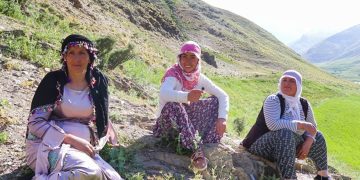 Three women Dengbejs sing traditional Kurdish songs on top of a mountain plateau