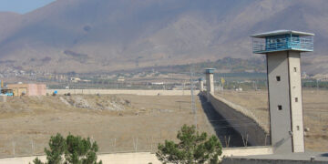Iranian prisoner dies after guards open fire on inmates, more than 100 injured
