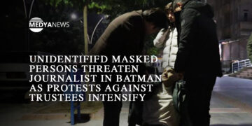 Masked figures reappear in Batman as protests over trustee appointments intensify, echoing the dirty war years of the 90s